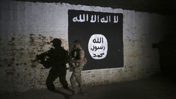 An Iraqi soldier inspects a recently-discovered train tunnel, adorned with an Islamic State group flag, that belonged to the former Baghdad to Mosul line, that was turned it to a training camp for IS fighters, in western Mosul, Iraq, Wednesday, March 1. 2017 - Sputnik International