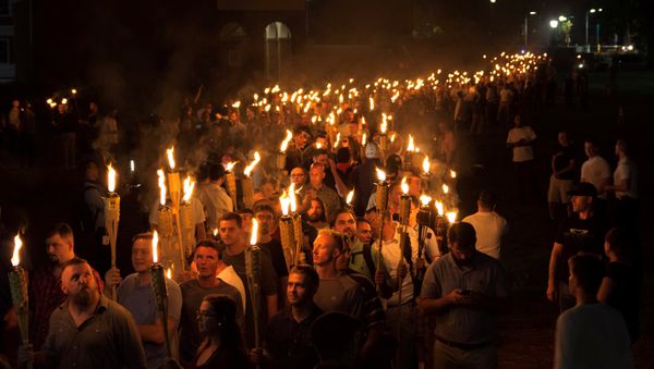 White nationalists carry torches on the grounds of the University of Virginia, on the eve of a planned Unite The Right rally in Charlottesville, Virginia, U.S - Sputnik International