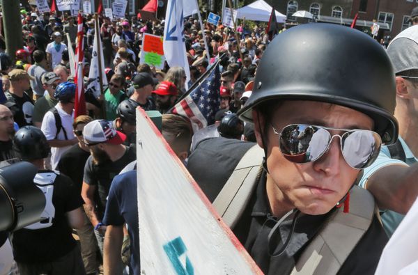 A white nationalist demonstrator with a helmet and shield walks into Lee Park in Charlottesville, Va., Saturday, Aug. 12, 2017. Hundreds of people chanted, threw punches, hurled water bottles and unleashed chemical sprays on each other Saturday after violence erupted at a white nationalist rally in Virginia. - Sputnik International