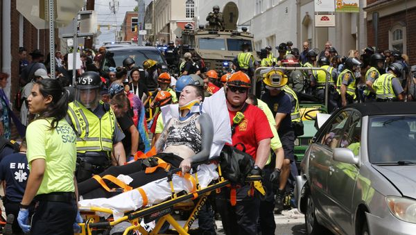 Rescue personnel help injured people after a car ran into a large group of protesters after a white nationalist rally in Charlottesville, Va., Saturday, Aug. 12, 2017. Rescue personnel help injured people after a car ran into a large group of protesters after a white nationalist rally in Charlottesville, Va., Saturday, Aug. 12, 2017. - Sputnik International