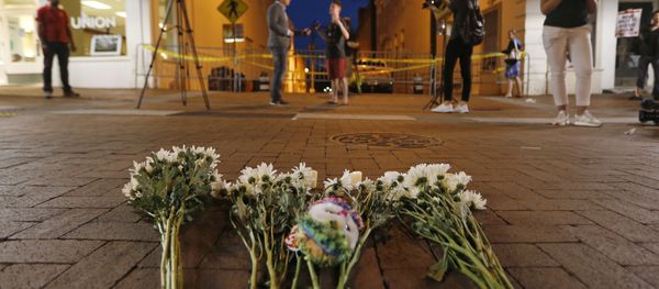 Flowers and other mementos are left at a makeshift memorial for the victims after a car plowed into a crowd of people peacefully protesting a white nationalist rally earlier in the day in Charlottesville, Va., Saturday, Aug. 12, 2017. (AP Flowers and other mementos are left at a makeshift memorial for the victims after a car plowed into a crowd of people peacefully protesting a white nationalist rally earlier in the day in Charlottesville, Va., Saturday, Aug. 12, 2017. (AP - Sputnik International