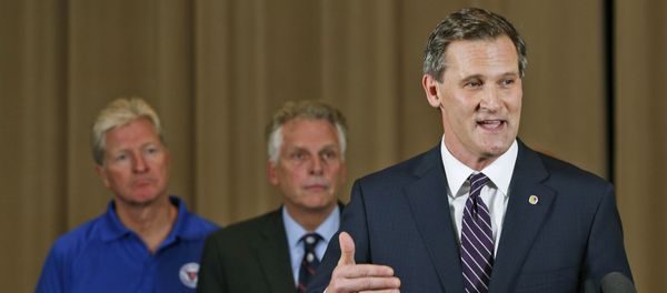 Charlottesville Mayor Mike Signer, right, gestures during a news conference concerning the white nationalist rally and violence as Virginia Gov. Terry McAuliffe, center, and Virginia Secretary of Public safety Brian Moran, left, listen in Charlottesville, Va Charlottesville Mayor Mike Signer, right, gestures during a news conference concerning the white nationalist rally and violence as Virginia Gov. Terry McAuliffe, center, and Virginia Secretary of Public safety Brian Moran, left, listen in Charlottesville, Va - Sputnik International