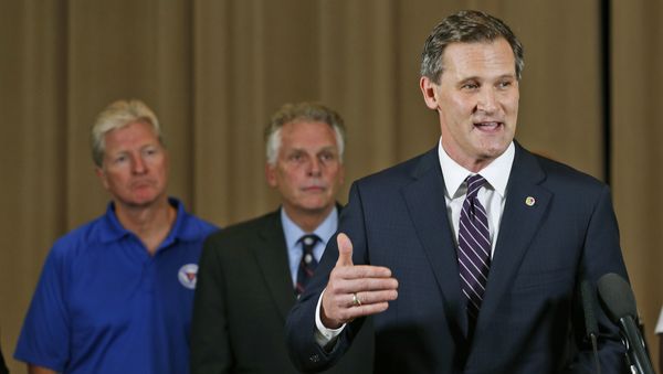 Charlottesville Mayor Mike Signer, right, gestures during a news conference concerning the white nationalist rally and violence as Virginia Gov. Terry McAuliffe, center, and Virginia Secretary of Public safety Brian Moran, left, listen in Charlottesville, Va Charlottesville Mayor Mike Signer, right, gestures during a news conference concerning the white nationalist rally and violence as Virginia Gov. Terry McAuliffe, center, and Virginia Secretary of Public safety Brian Moran, left, listen in Charlottesville, Va - Sputnik International