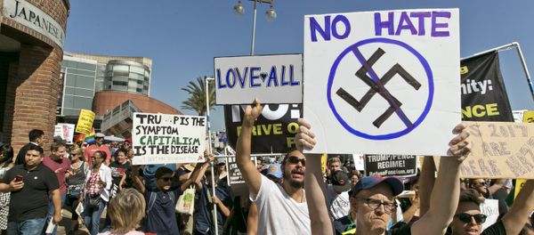 Demonstrators march in downtown Los Angeles on Sunday, Aug. 13, 2017. Protesters decrying hatred and racism converged around the country Sunday, the day after a white supremacist rally that spiraled into violence in Charlottesville, Va - Sputnik International