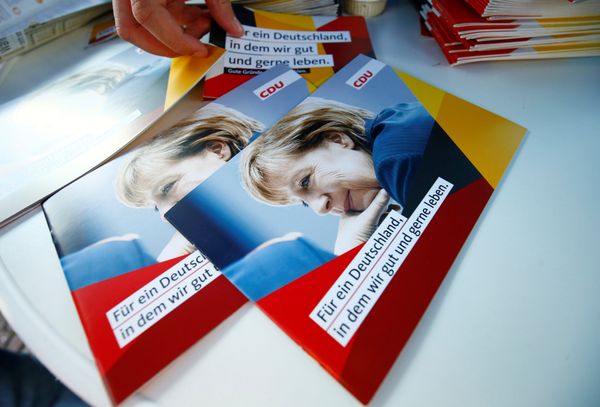 Brochures, showing German Chancellor Angela Merkel, top candidate of the Christian Democratic Union Party (CDU) are seen during an election rally for the upcoming federal elections in Gelnhausen, near Frankfurt, Germany August 14, 2017 - Sputnik International
