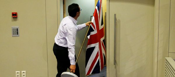 An official carries a Union Jack flag ahead of a news conference by Britain's Secretary of State for Exiting the European Union David Davis and European Union's chief Brexit negotiator Michel Barnier in Brussels, Belgium July 20, 2017 An official carries a Union Jack flag ahead of a news conference by Britain's Secretary of State for Exiting the European Union David Davis and European Union's chief Brexit negotiator Michel Barnier in Brussels, Belgium July 20, 2017 - Sputnik International