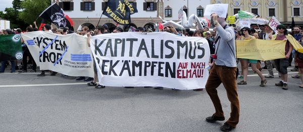 (File) Anti G7-protesters hold a giant banner reading Fight capitalism during a rally in Garmisch-Partenkirchen, southern Germany on June 6, 2015 (File) Anti G7-protesters hold a giant banner reading Fight capitalism during a rally in Garmisch-Partenkirchen, southern Germany on June 6, 2015 - Sputnik International