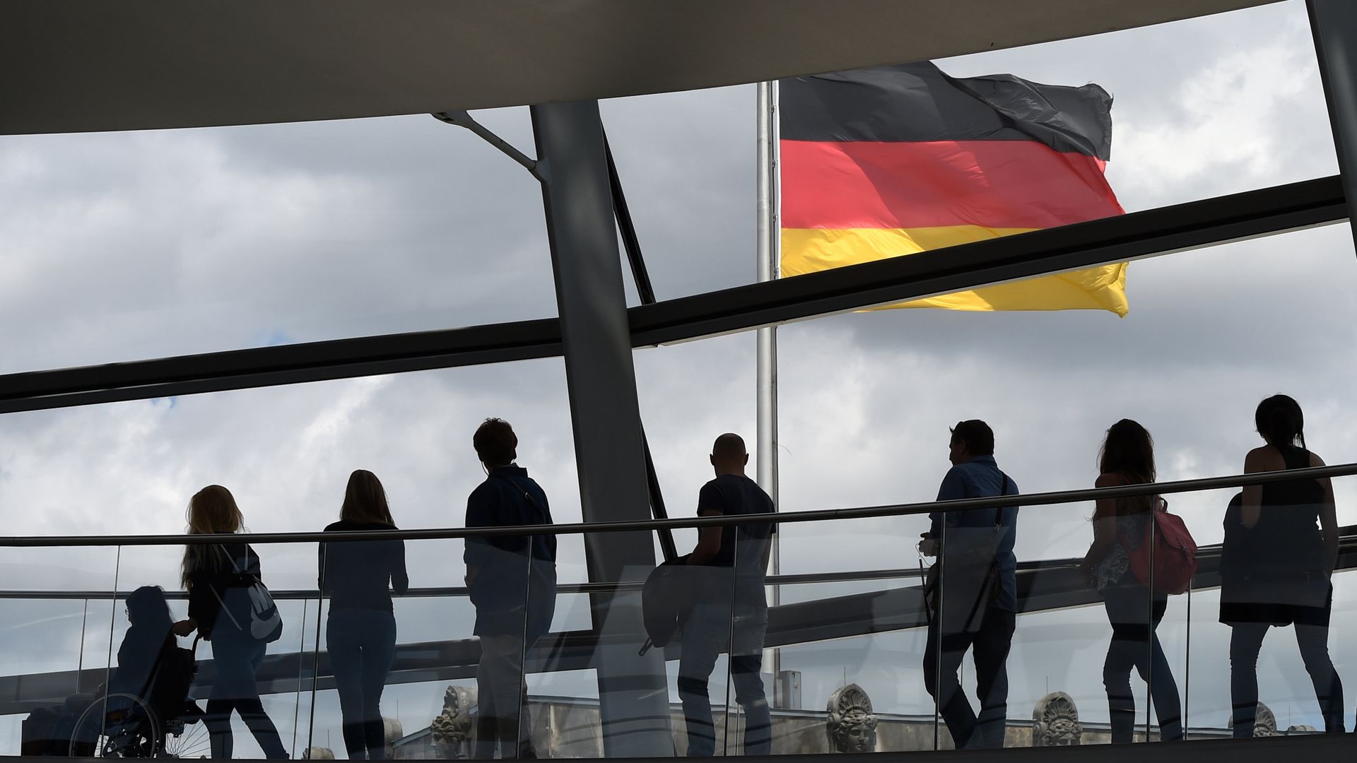 Visitors walk in the glass cupola of the Reichstag building that hosts the German parliament (Bundestag) and look at a German flag in Berlin, Germany, on June 10, 2016. Visitors walk in the glass cupola of the Reichstag building that hosts the German parliament (Bundestag) and look at a German flag in Berlin, Germany, on June 10, 2016. - Sputnik International, 1920, 14.03.2023