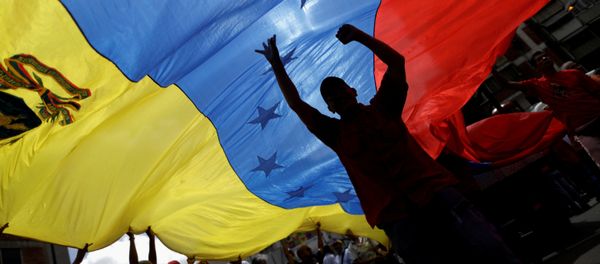 Pro-government supporters holding a Venezuela's flag attend a rally against U.S President Donald Trump in Caracas, Venezuela August 14, 2017 Pro-government supporters holding a Venezuela's flag attend a rally against U.S President Donald Trump in Caracas, Venezuela August 14, 2017 - Sputnik International