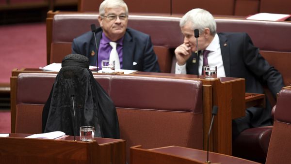 Sen. Pauline Hanson, bottom left, wears a burqa during question time in the Senate chamber at Parliament House in Canberra, Australia, Thursday, Aug. 17, 2017. Sen. Pauline Hanson, bottom left, wears a burqa during question time in the Senate chamber at Parliament House in Canberra, Australia, Thursday, Aug. 17, 2017. - Sputnik International