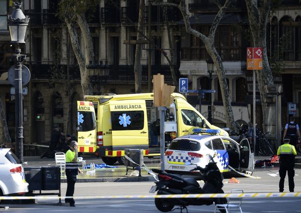 A policemen and a medical staff member stand past police cars and an ambulance in a cordoned off area after a van ploughed into the crowd, injuring several persons on the Rambla in Barcelona on August 17, 2017 A policemen and a medical staff member stand past police cars and an ambulance in a cordoned off area after a van ploughed into the crowd, injuring several persons on the Rambla in Barcelona on August 17, 2017 - Sputnik International