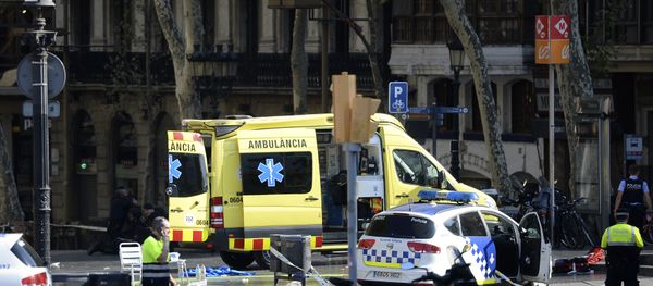 A policemen and a medical staff member stand past police cars and an ambulance in a cordoned off area after a van ploughed into the crowd, injuring several persons on the Rambla in Barcelona on August 17, 2017 A policemen and a medical staff member stand past police cars and an ambulance in a cordoned off area after a van ploughed into the crowd, injuring several persons on the Rambla in Barcelona on August 17, 2017 - Sputnik International