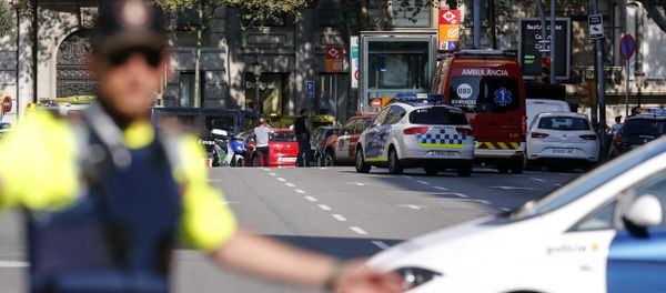 A policemen stand as he blocks the street to a cordoned off area after a van ploughed into the crowd, injuring several persons on the Rambla in Barcelona on August 17, 2017 - Sputnik International