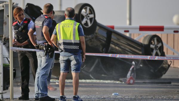 Police officers stand near an overturned car onto a platform at the spot where terrorists were intercepted by police in Cambrils, Spain, Friday, Aug. 18, 2017 Police officers stand near an overturned car onto a platform at the spot where terrorists were intercepted by police in Cambrils, Spain, Friday, Aug. 18, 2017 - Sputnik International