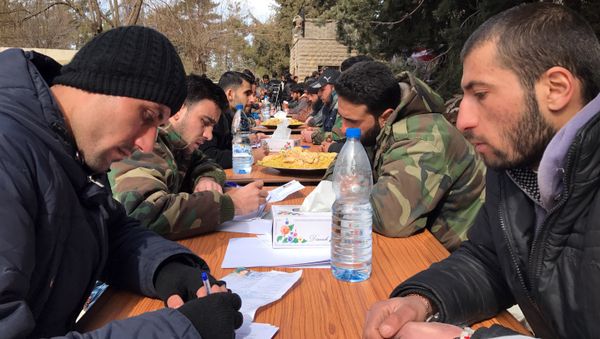 Militants hand in personal weapons to Syrian army representatives as part of the people's reconciliation program. File photo - Sputnik International
