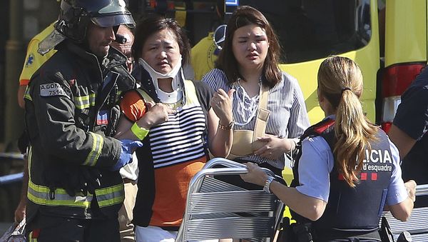 Injured people are treated in Barcelona, Spain, Thursday, Aug. 17, 2017 after a white van jumped the sidewalk in the historic Las Ramblas district, crashing into a summer crowd of residents and tourists and injuring several people, police said Injured people are treated in Barcelona, Spain, Thursday, Aug. 17, 2017 after a white van jumped the sidewalk in the historic Las Ramblas district, crashing into a summer crowd of residents and tourists and injuring several people, police said - Sputnik International