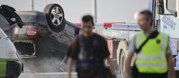 Police officers walk near an overturned car onto a platform at the spot where terrorists were intercepted by police in Cambrils, Spain, Friday, Aug. 18, 2017 Police officers walk near an overturned car onto a platform at the spot where terrorists were intercepted by police in Cambrils, Spain, Friday, Aug. 18, 2017 - Sputnik International
