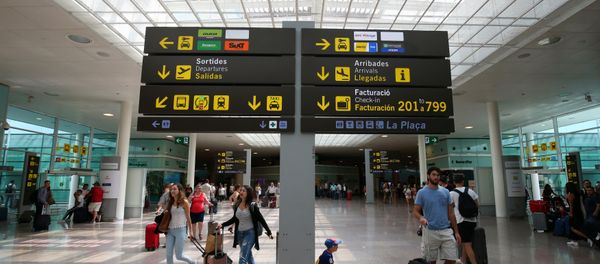 People walk under a sign at Barcelona-El Prat airport, Spain August 4, 2017 People walk under a sign at Barcelona-El Prat airport, Spain August 4, 2017 - Sputnik International
