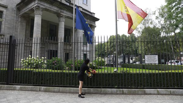The Spanish and the European flag fly at half mast as a woman fixes flowers at the fence of the Spanish embassy in Berlin, on August 18, 2017 in tribute to victims of the Barcelona attack The Spanish and the European flag fly at half mast as a woman fixes flowers at the fence of the Spanish embassy in Berlin, on August 18, 2017 in tribute to victims of the Barcelona attack - Sputnik International