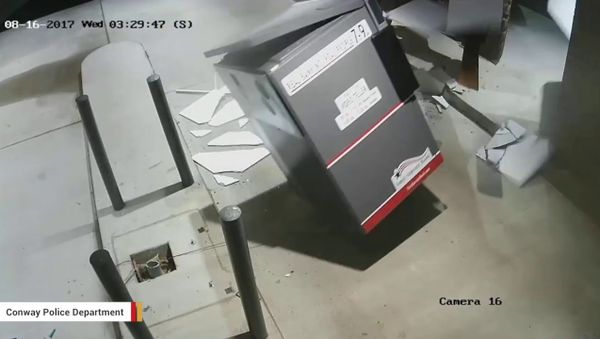 Screenshot of surveillance footage shows thieves using a forklift to steal an ATM in Arkansas. Screenshot of surveillance footage shows thieves using a forklift to steal an ATM in Arkansas. - Sputnik International