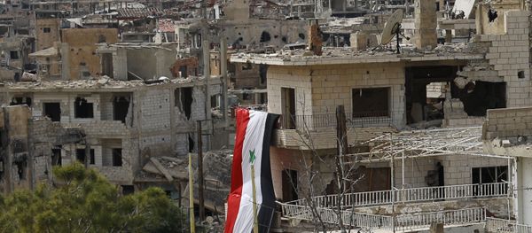 In this May 18, 2017, photo, a Syrian National flag hangs out of a damaged building at the mountain resort town of Zabadani in the Damascus countryside, Syria. - Sputnik International