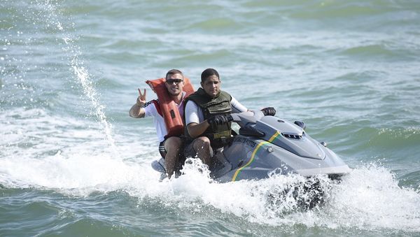 In this June 10, 2014 photo released by the German Football federation, DFB, former German national soccer player Lukas Podolski, left, rides on a jet-ski off Santo Andre, Brazil. - Sputnik International