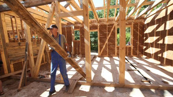Construction of wooden houses. File photo - Sputnik International