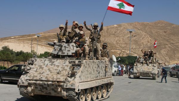Lebanese army soldiers sit a top an armoured personnel carrier (APC) as they drive in the eastern town of Ras Baalbek, on August 21, 2017, upon returning from the mountainous frontline where an offensive against the Islamic State group on the country's eastern border with Syria after capturing a third of the territory IS held in the region. - Sputnik International