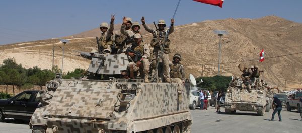 Lebanese army soldiers sit a top an armoured personnel carrier (APC) as they drive in the eastern town of Ras Baalbek, on August 21, 2017, upon returning from the mountainous frontline where an offensive against the Islamic State group on the country's eastern border with Syria after capturing a third of the territory IS held in the region. Lebanese army soldiers sit a top an armoured personnel carrier (APC) as they drive in the eastern town of Ras Baalbek, on August 21, 2017, upon returning from the mountainous frontline where an offensive against the Islamic State group on the country's eastern border with Syria after capturing a third of the territory IS held in the region. - Sputnik International