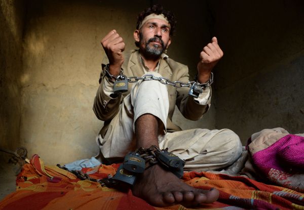 In this photograph taken on April 25, 2017, a mentally ill Afghan patient sits chained to a wall at the Mia Ali Baba holy shrine in the village of Samar Khel on the outskirts of Jalalabad In this photograph taken on April 25, 2017, a mentally ill Afghan patient sits chained to a wall at the Mia Ali Baba holy shrine in the village of Samar Khel on the outskirts of Jalalabad - Sputnik International