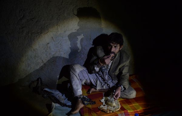 In this photograph taken on May 7, 2017, a mentally ill Afghan patient eats bread as he sits chained to a wall at the Mia Ali Baba holy shrine in the village of Samar Khel on the outskirts of Jalalabad In this photograph taken on May 7, 2017, a mentally ill Afghan patient eats bread as he sits chained to a wall at the Mia Ali Baba holy shrine in the village of Samar Khel on the outskirts of Jalalabad - Sputnik International