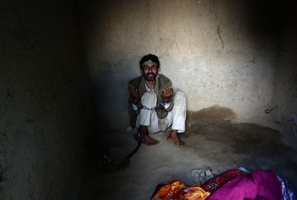 In this photograph taken on April 27, 2017, a mentally ill Afghan patient prays as he is chained at the Mia Ali Baba holy shrine in the village of Samar Khel on the outskirts of Jalalabad In this photograph taken on April 27, 2017, a mentally ill Afghan patient prays as he is chained at the Mia Ali Baba holy shrine in the village of Samar Khel on the outskirts of Jalalabad - Sputnik International