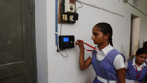 An Indian schoolgirl uses an electronic ID card to mark her attendance at a school in the first Indian 'Digital Village' in Akodara, some 90 kms from Ahmedabad, on 8 July 2015. - Sputnik International