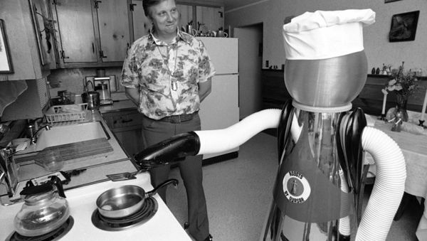 Ben Skora of Palo Heights, Ill., and his robot “Arok” are shown on Feb. 2, 1977. The robot can be programmed to do tasks of repetition or individual tasks through push-button control. He can help with repairs on himself (holding soldering irons, meters, etc) . He does butler work and acts as a waiter). - Sputnik International