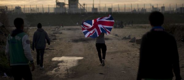 In this Tuesday, Oct. 25, 2016 file photo a man runs with a British flag inside a makeshift camp known as the jungle near Calais, northern France - Sputnik International