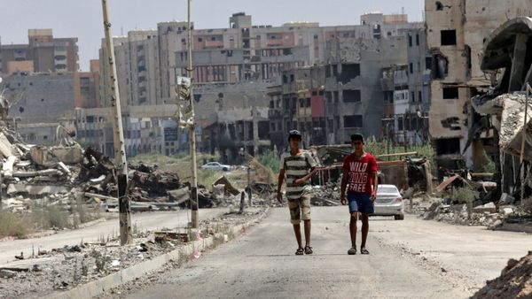 Men walk near destroyed buildings in Sabri, a central Benghazi district, Libya, August 12, 2017 Men walk near destroyed buildings in Sabri, a central Benghazi district, Libya, August 12, 2017 - Sputnik International