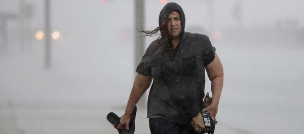 Hillary Lebeb walks along the seawall in Galveston, Texas as Hurricane Harvey intensifies in the Gulf of Mexico Friday, Aug. 25, 2017. Hillary Lebeb walks along the seawall in Galveston, Texas as Hurricane Harvey intensifies in the Gulf of Mexico Friday, Aug. 25, 2017. - Sputnik International