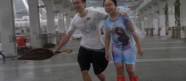 People play in the strong wind from Typhoon Hato on the waterfront of Victoria Habour in Hong Kong, Wednesday, Aug. 23, 2017. People play in the strong wind from Typhoon Hato on the waterfront of Victoria Habour in Hong Kong, Wednesday, Aug. 23, 2017. - Sputnik International