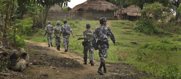 In this Friday, July 14, 2017 photo, Myanmar Border Guard Police (BGP) officers walk along a path ahead of journalists in Tin May village, in which Myanmar government and military claim the existence of Muslim terrorists in Buthidaung, Rakhine State, Myanmar. - Sputnik International