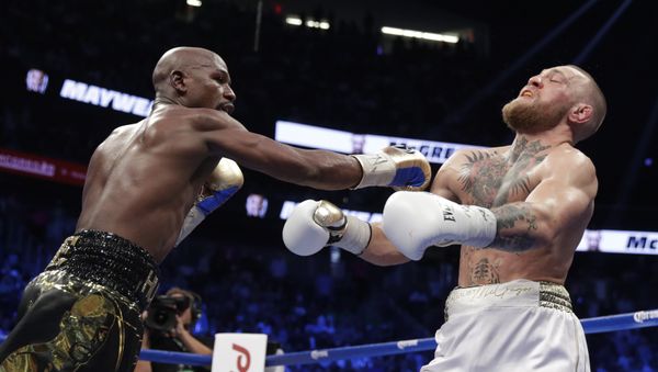 Floyd Mayweather Jr. hits Conor McGregor in a super welterweight boxing match Saturday, Aug. 26, 2017, in Las Vegas. Floyd Mayweather Jr. hits Conor McGregor in a super welterweight boxing match Saturday, Aug. 26, 2017, in Las Vegas. - Sputnik International