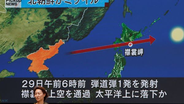 A woman walks past a large TV screen showing news about North Korea's missile launch in Tokyo, Japan, August 29, 2017. A woman walks past a large TV screen showing news about North Korea's missile launch in Tokyo, Japan, August 29, 2017. - Sputnik International