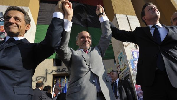 French President Nicholas Sarkozy, left, Libya's NTC leader Mustafa Abdul-Jalil, center, and British Prime Minister David Cameron, right, gesture during their visit to Benghazi, Libya, Thursday, Sept. 15, 2011. - Sputnik International