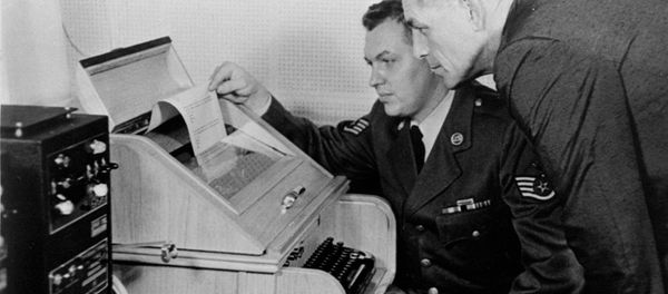 This Aug.30, 1963 black-and-white file photo shows the White House Kremlin hot line providing direct communication for emergency use by the Chief of Staff in Washington and Moscow, becaming operational. Air Force Sgt. John Bretoski, left, and Army Lt. Col. Charles Fitzgerald, man the equipment in the Pentagon during a test run. The Pentagon is the U.S. operating terminal for both the land line-transocean circuit and the alternate radio circuit, with a direct relay to the White House. This Aug.30, 1963 black-and-white file photo shows the White House Kremlin hot line providing direct communication for emergency use by the Chief of Staff in Washington and Moscow, becaming operational. Air Force Sgt. John Bretoski, left, and Army Lt. Col. Charles Fitzgerald, man the equipment in the Pentagon during a test run. The Pentagon is the U.S. operating terminal for both the land line-transocean circuit and the alternate radio circuit, with a direct relay to the White House. - Sputnik International