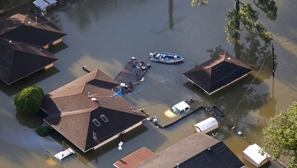 A boat sits near flooded homes in the aftermath of Tropical Storm Harvey in Beaumont, Texas, Thursday, Aug. 31, 2017. A boat sits near flooded homes in the aftermath of Tropical Storm Harvey in Beaumont, Texas, Thursday, Aug. 31, 2017. - Sputnik International