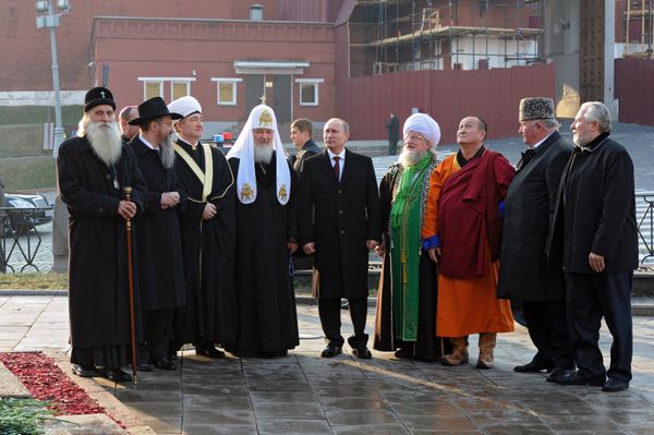 Surrounded by the leaders of Russia's traditional confessions, President Putin lays flowers at monument to Minin and Pozharsky on Red Square. File photo. - Sputnik International