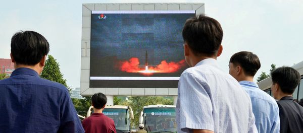 North Koreans watch a news report showing North Korea's Hwasong-12 intermediate-range ballistic missile launch on electronic screen at Pyongyang station in Pyongyang, North Korea, in this photo taken by Kyodo August 30, 2017 North Koreans watch a news report showing North Korea's Hwasong-12 intermediate-range ballistic missile launch on electronic screen at Pyongyang station in Pyongyang, North Korea, in this photo taken by Kyodo August 30, 2017 - Sputnik International