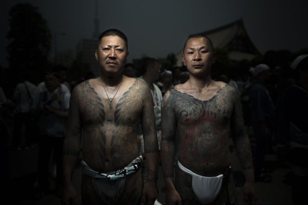 In this picture taken on May 20, 2017, men pose for photographs showing their Irezumi Japanese traditional tattoos related to the Yakuza's universe, during the Sanja Matsuri festival in Tokyo - Sputnik International