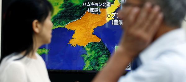 People walk past a street monitor showing a news report about North Korea's nuclear test, in Tokyo, Japan, September 3, 2017 People walk past a street monitor showing a news report about North Korea's nuclear test, in Tokyo, Japan, September 3, 2017 - Sputnik International