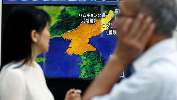 People walk past a street monitor showing a news report about North Korea's nuclear test, in Tokyo, Japan, September 3, 2017 People walk past a street monitor showing a news report about North Korea's nuclear test, in Tokyo, Japan, September 3, 2017 - Sputnik International