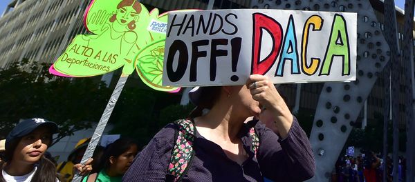 Young immigrants and supporters walk holding signs during a rally in support of Deferred Action for Childhood Arrivals (DACA) in Los Angeles, California - Sputnik International